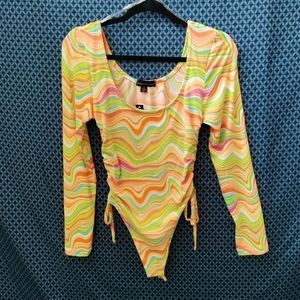 Almost Famous - Junior's long sleeve bodysuit with colorful swirl. New. Size - M